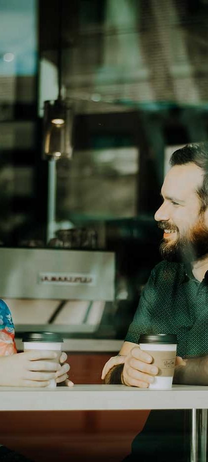 Two people casually talk in cafe