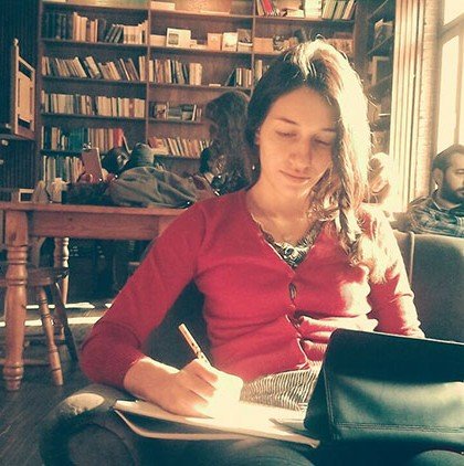 Girl writing in cafe