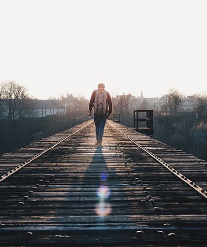 Man walking towards sun
