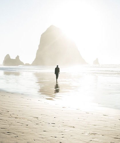 Man walks alone by the beach
