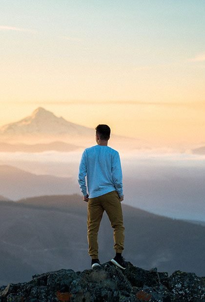 Guy standing on top of a cliff