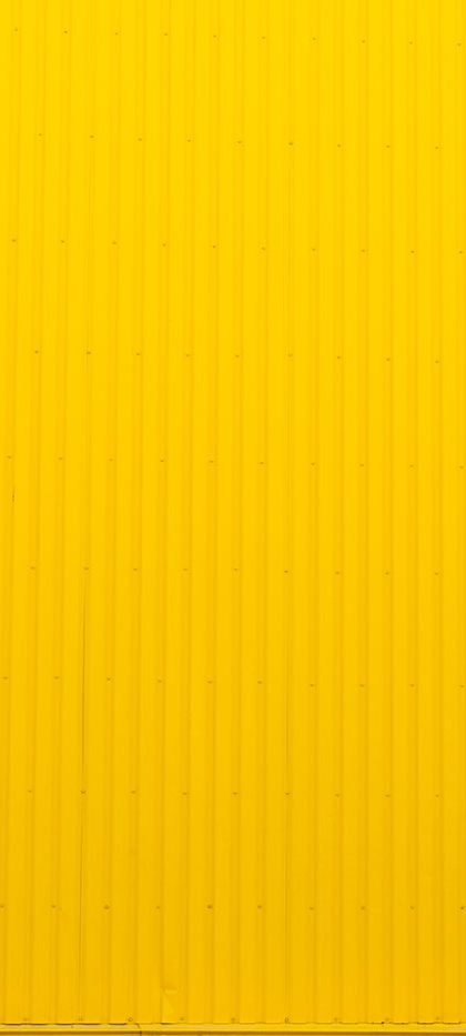 Girl walking infront of yellow background